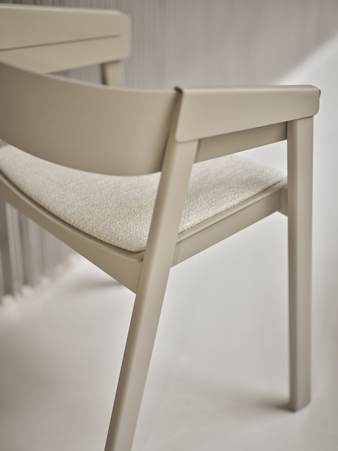 A close up of a cozy and elegant armchair. Combines neutral sophistication with a contemporary silhouette, perfect for versatile seating arrangements.