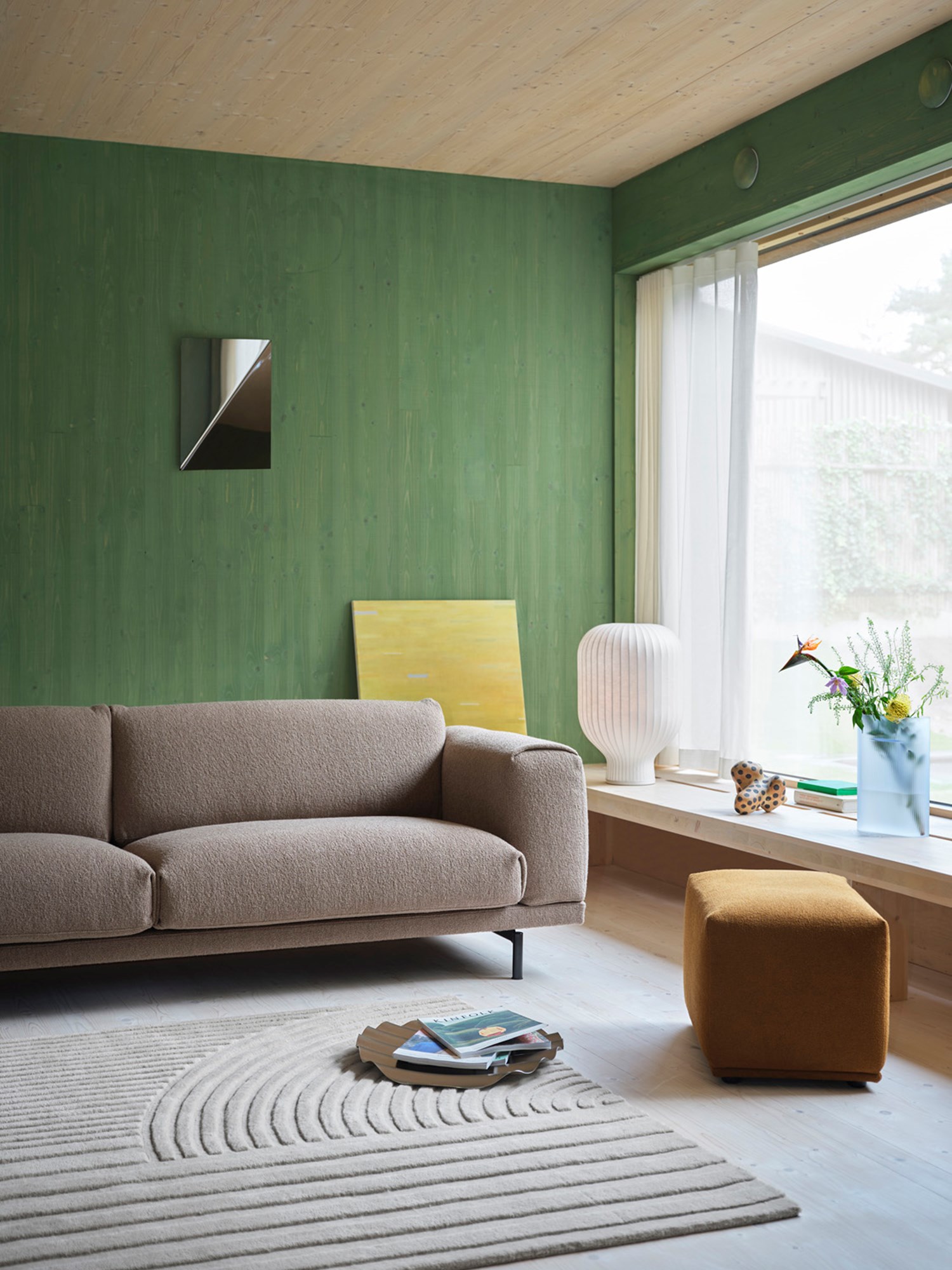 The Muuto Rest Sofa is elegantly styled with a burnt orange Relevo Rug and complemented by a Strand Table Lamp. A Gaze Mirror hanging on the wall adds a sophisticated, sculptural ambiance to the room. The Muuto Rest Sofa is elegantly styled with a burnt orange Relevo Rug and complemented by a Strand Table Lamp. A Gaze Mirror hanging on the wall adds a sophisticated, sculptural ambiance to the room.