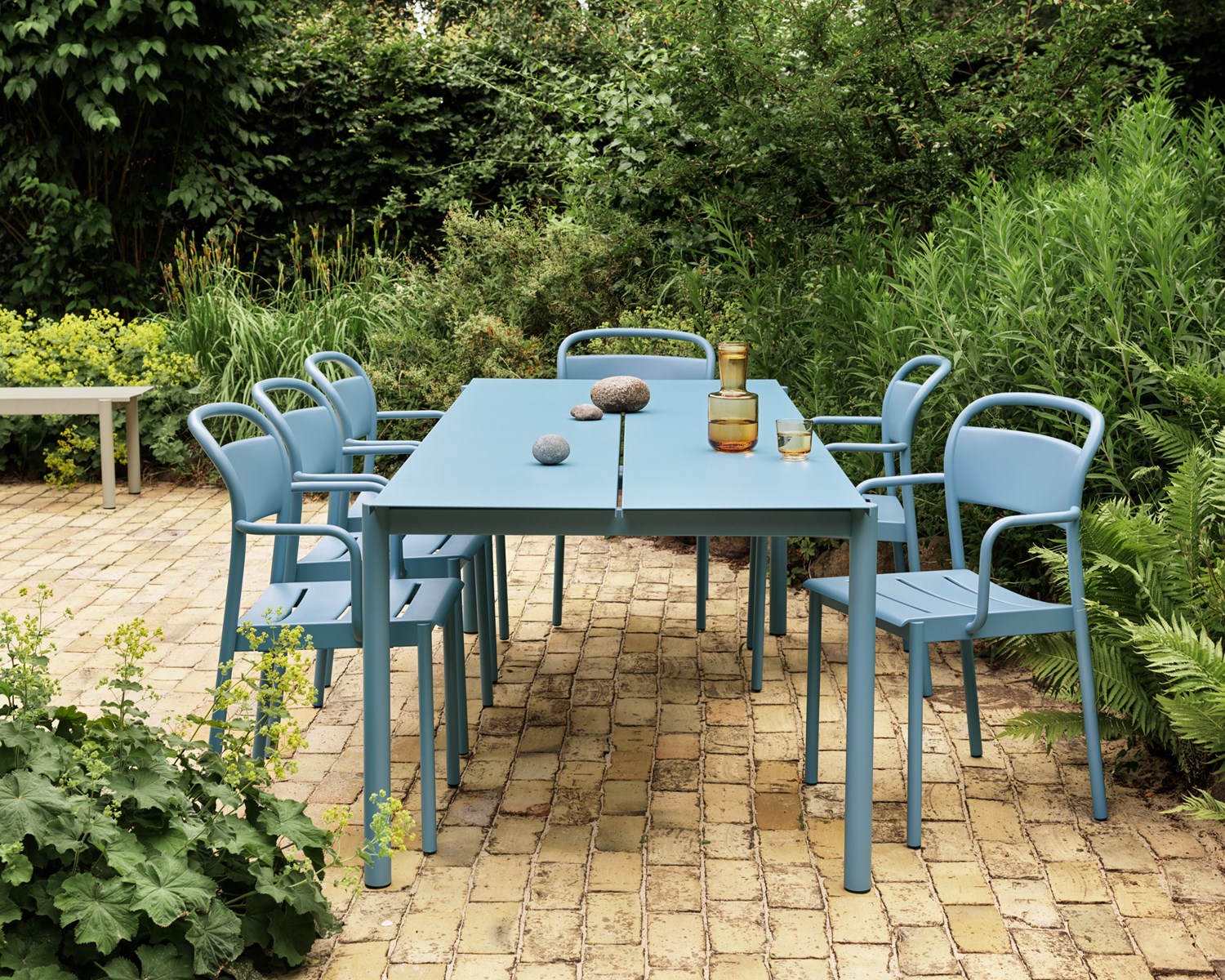 Linear Steel Table 220x90 cm in Pale Blue - Linear Steel Armchair Pale Blue - Raise Carafe & Glass in Burnt Orange Linear Steel Table 220x90 cm in Pale Blue - Linear Steel Armchair Pale Blue - Raise Carafe & Glass in Burnt Orange