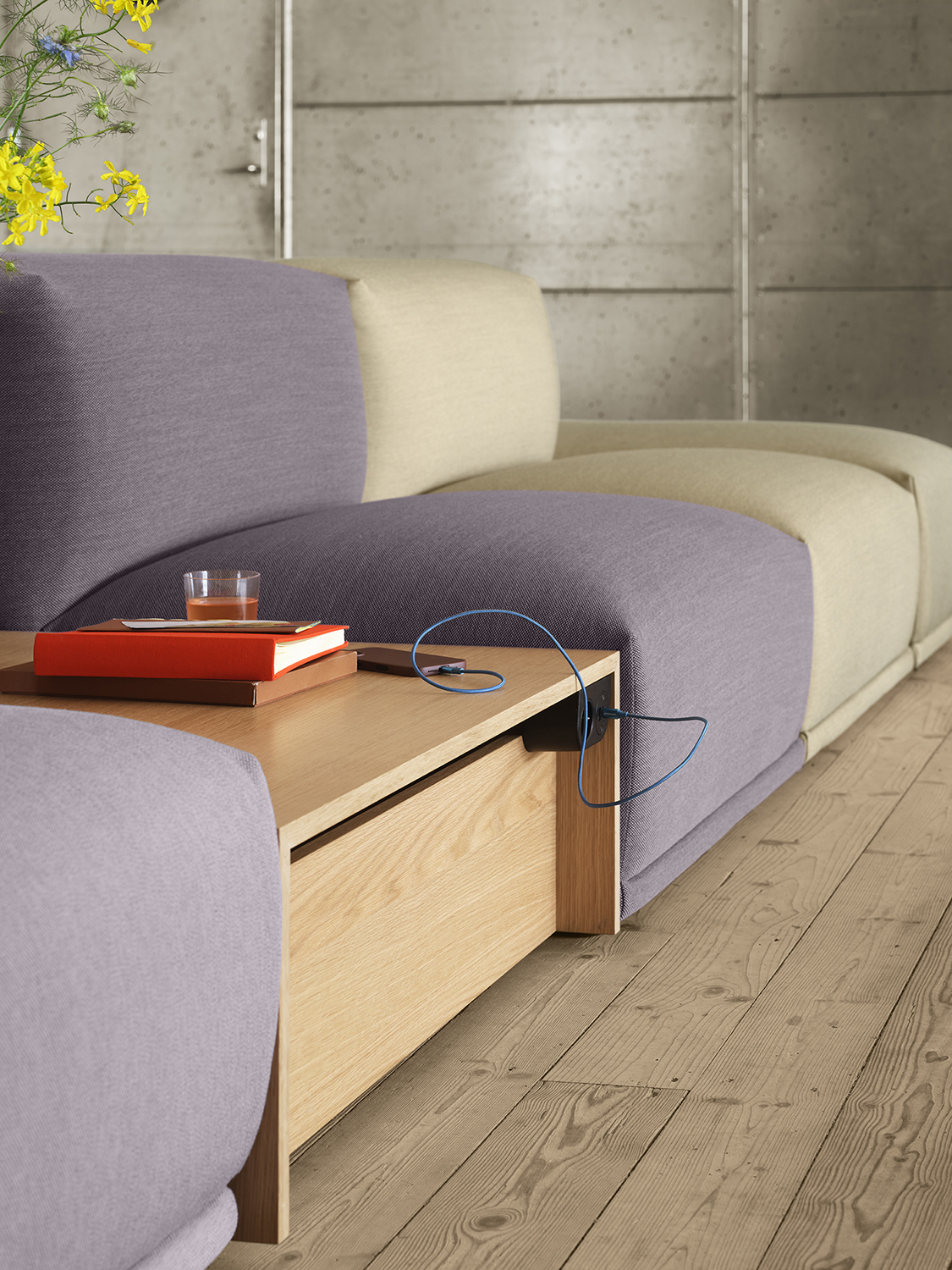 Close-up of a light purple Connect Sofa with a wooden Connect Table placed between the sofa modules, creating a personal and cohesive look.