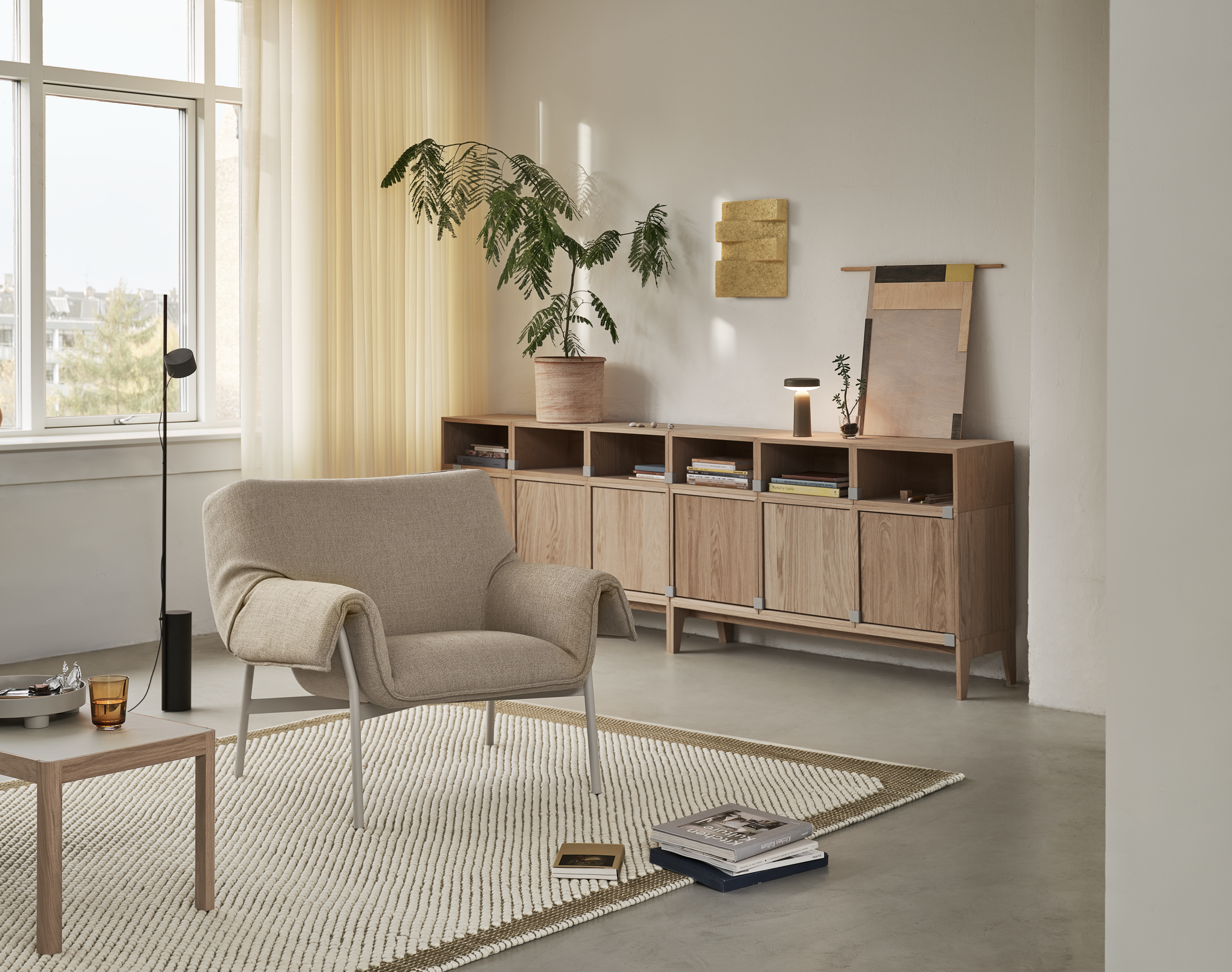 Wrap Lounge Chair in Ecriture 240/Grey, Pebble Rug 200x300 cm in Brown Green, Workshop Coffee Table in Warm Grey Linoleum/Oak, Stacked Storage System in Oak, Ease Portable Lamp in Taupe, Platform Tray in Grey, Raise Glass in Burnt Orange, Post Floor Lamp in Black