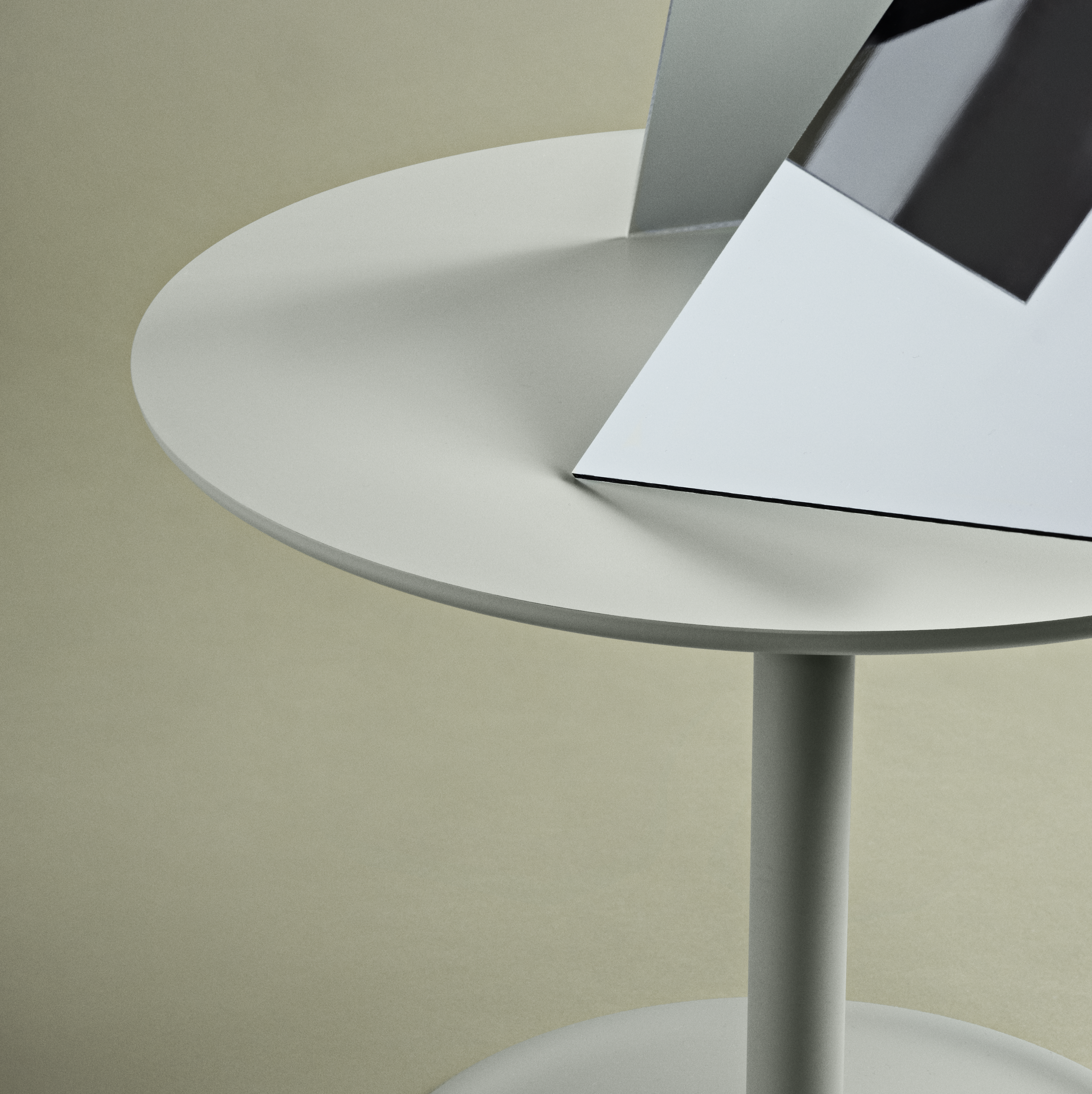 Muuto Soft Side Table in dusty green shown in a minimalist setting, highlighting its clean lines.